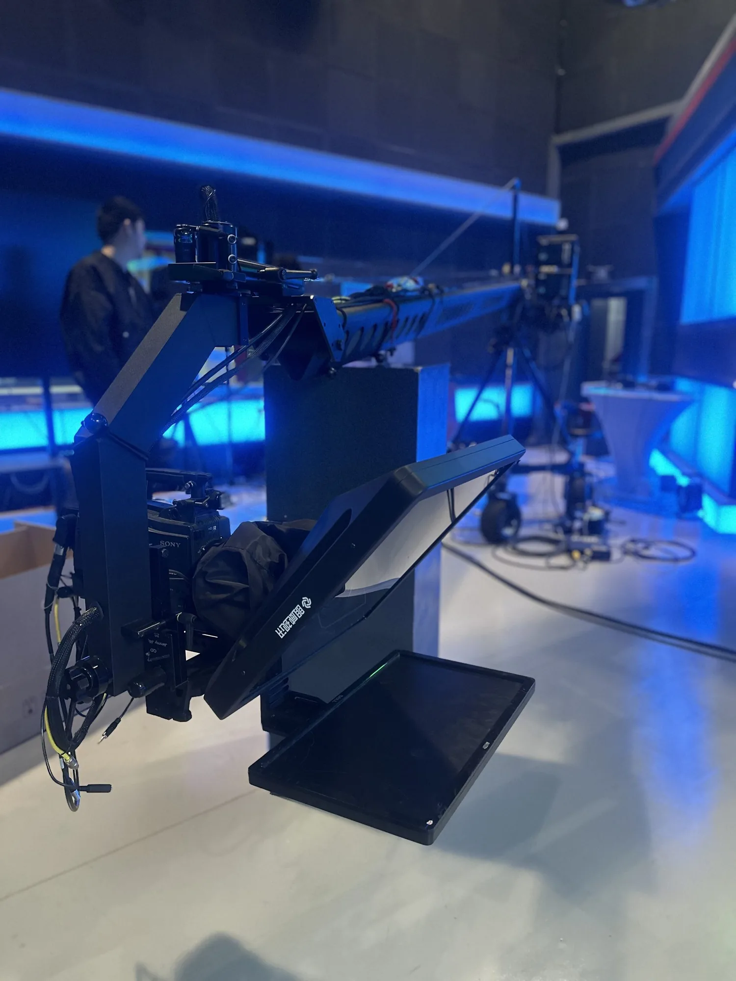 Jib Crane Teleprompter mounted on a jib arm over a broadcast camera
